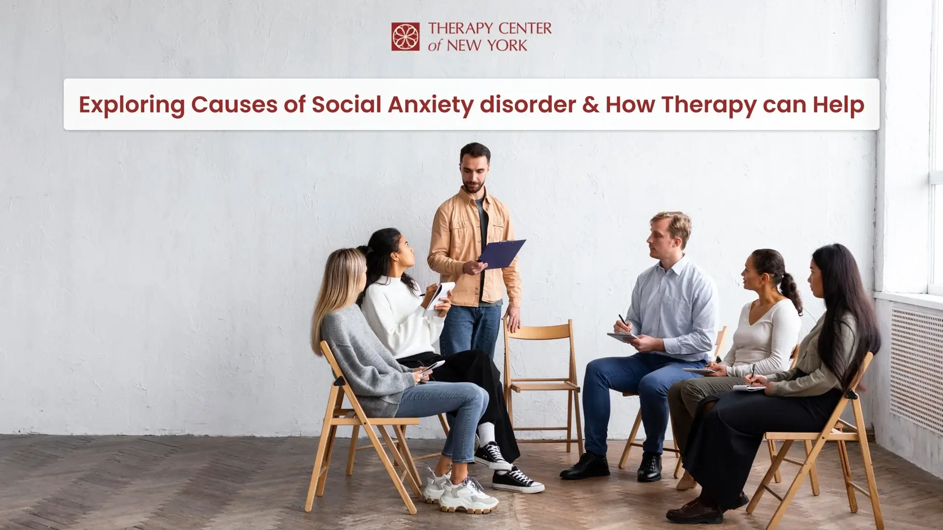 Group therapy session for social anxiety disorder at Therapy Center of New York, with a therapist guiding five seated participants in discussion.