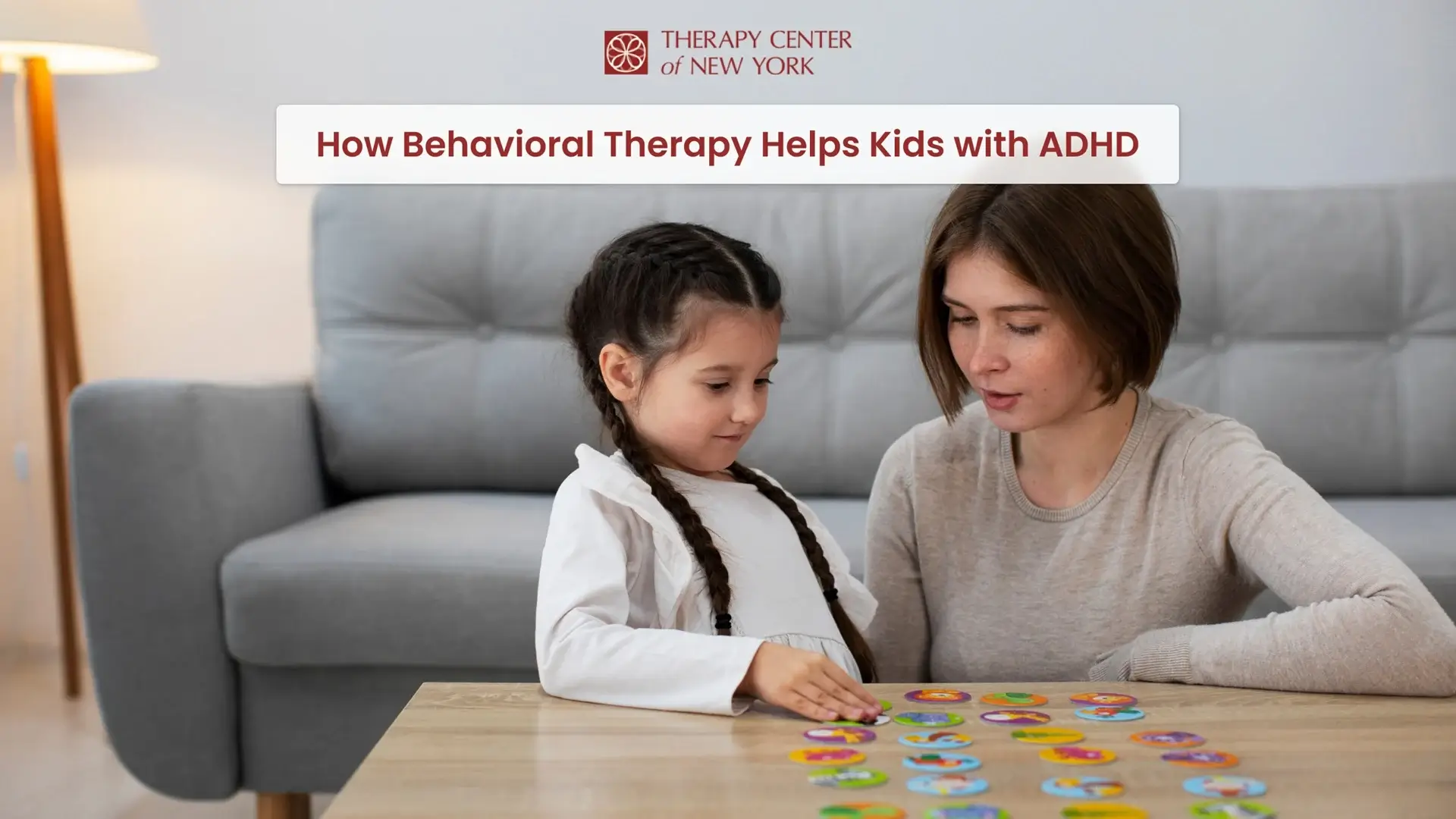Therapist using a colorful matching game during a behavioral therapy session with a young girl for ADHD at Therapy Center of New York.