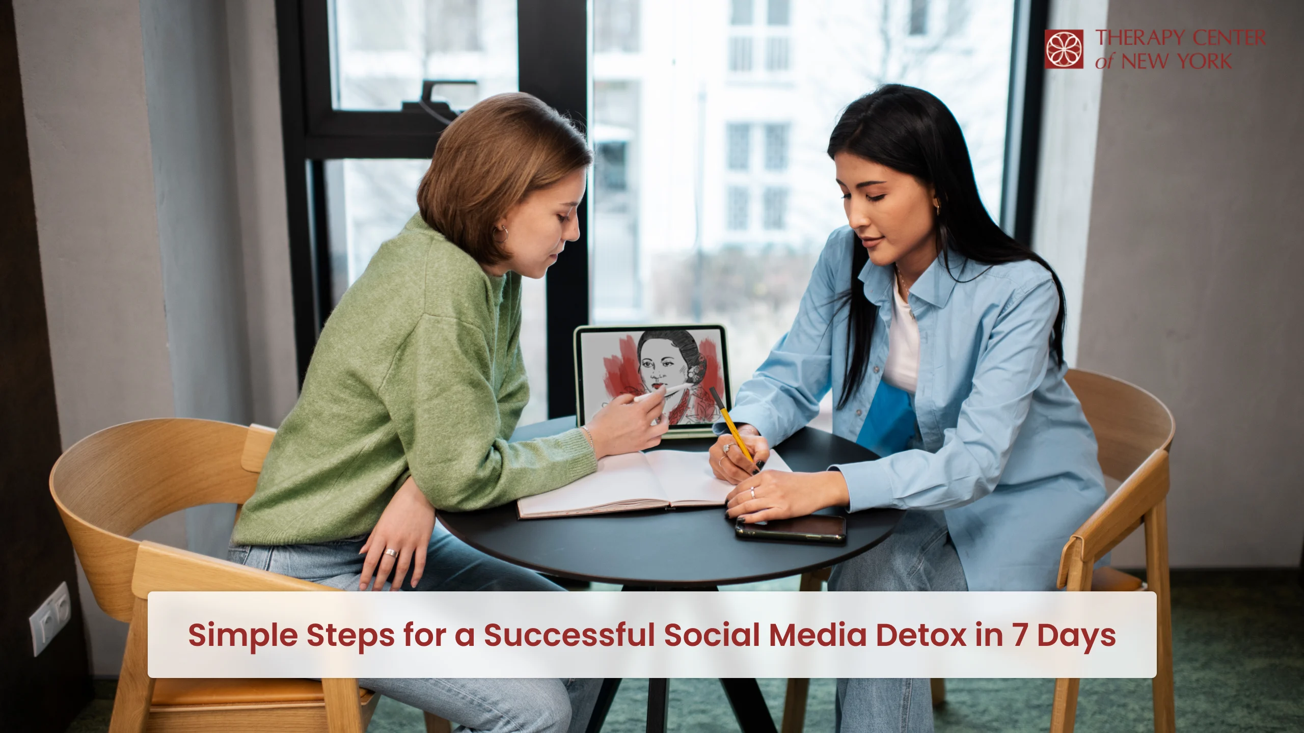 Two women discussing social media detox strategies with notes and tablet at Therapy Center of New York session