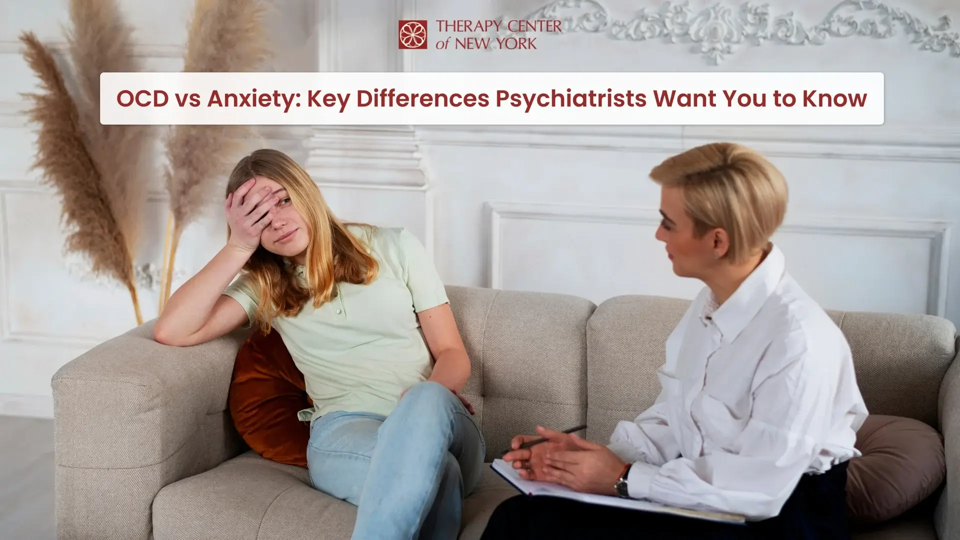 Distressed woman in a therapy session for OCD and anxiety, talking with a psychiatrist holding a notepad at Therapy Center of New York.